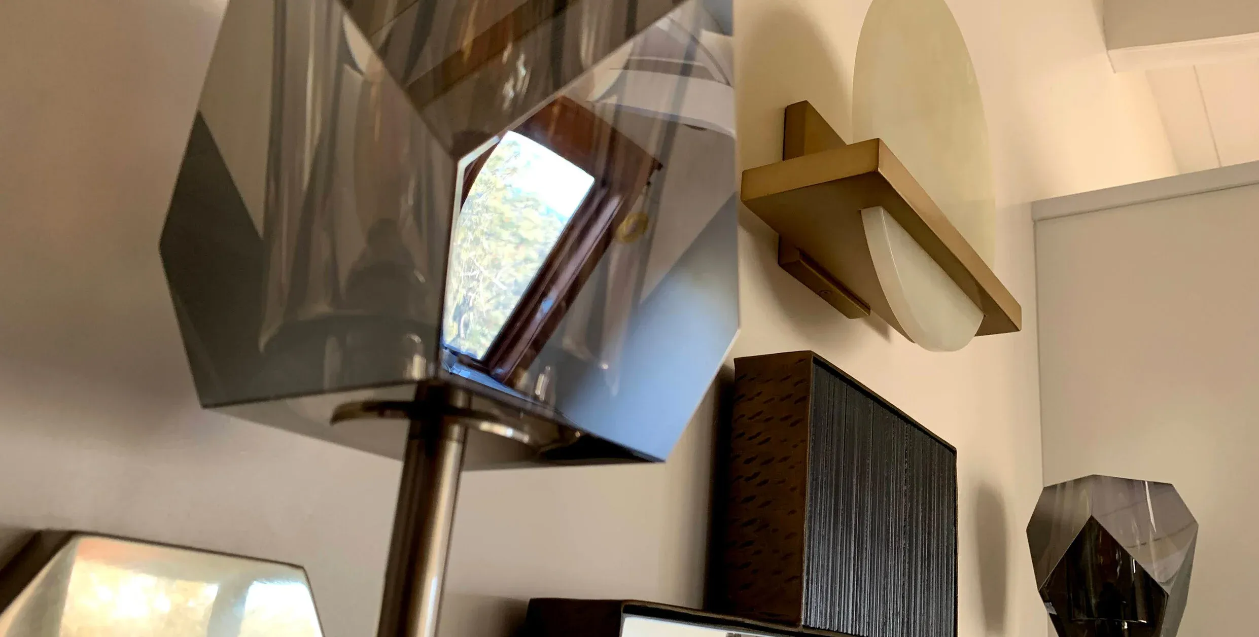 A bathroom with faceted vanity sconces
