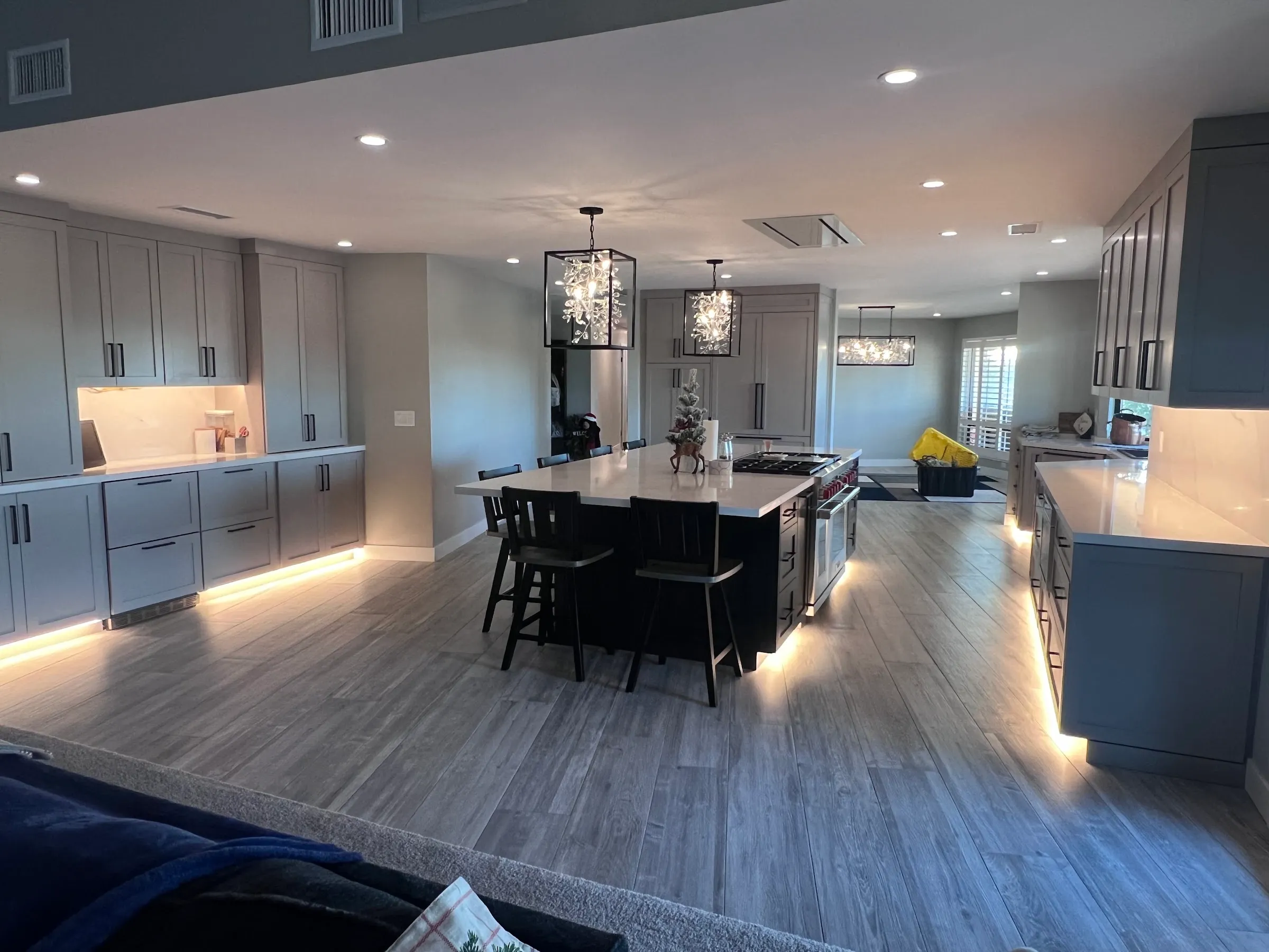 A kitchen with under-cabinet and toe-kick LED lighting