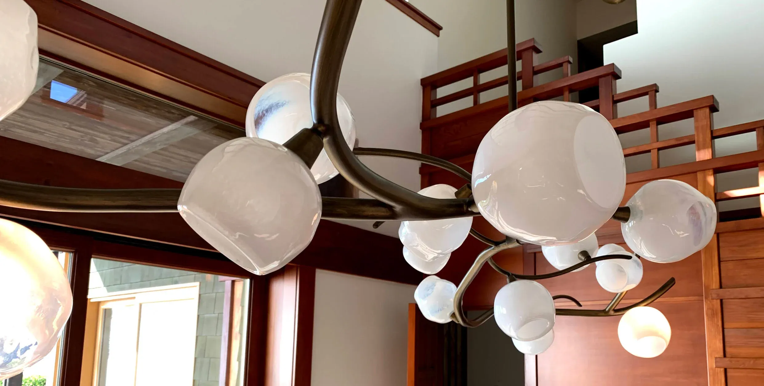 A multi-globe chandelier in a stairwell